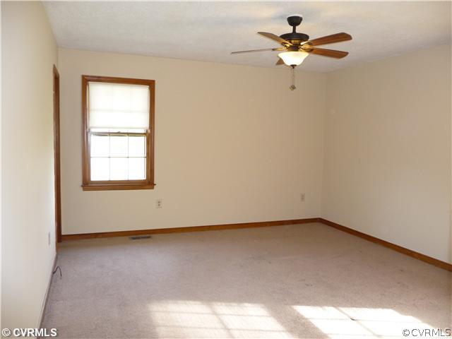 7701 Drexelbrook Road Chesterfield, VA 23832 - Photo 7 of 12 an empty room with a window and a ceiling fan