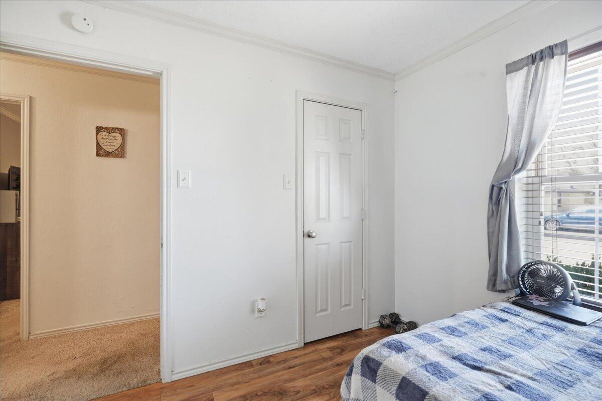2101 76th Street Lubbock, TX 79423 - Photo 17 of 20 a bedroom with a bed and a window