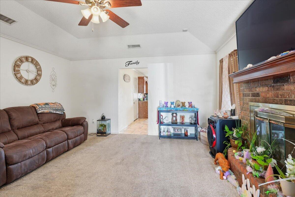 2101 76th Street Lubbock, TX 79423 - Photo 5 of 20 a living room with furniture and a fireplace