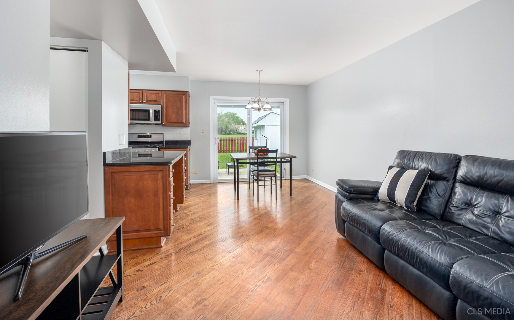 658 Cutter Lane Elk Grove Village, IL 60007 - Photo 11 of 33 a living room with furniture and a dining table with kitchen view