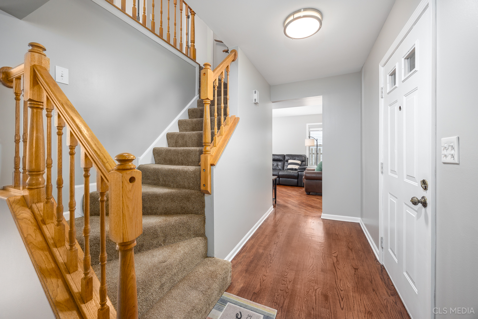 658 Cutter Lane Elk Grove Village, IL 60007 - Photo 2 of 33 a view of a hallway with wooden floor and staircase