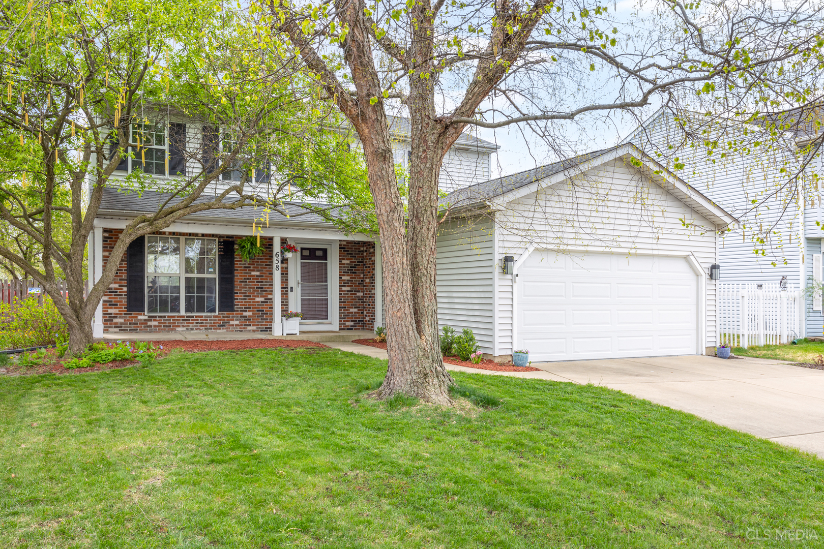658 Cutter Lane Elk Grove Village, IL 60007 - Photo 27 of 33 a front view of a house with a yard and garage