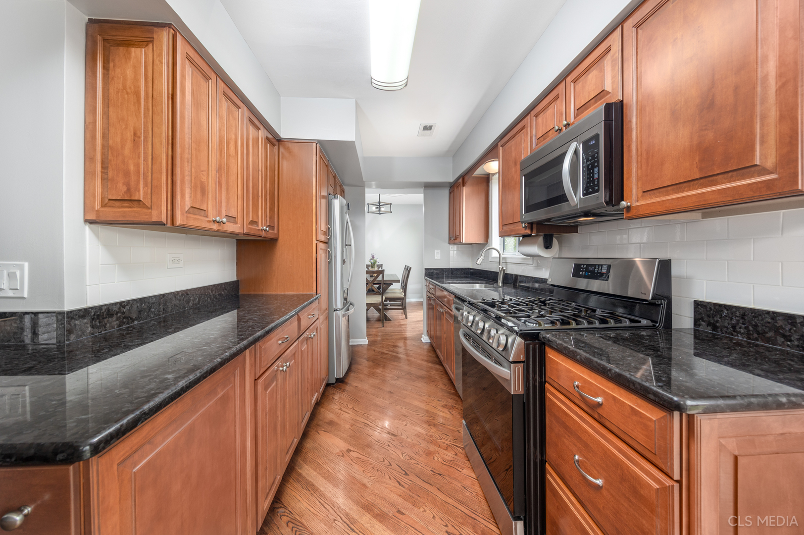 658 Cutter Lane Elk Grove Village, IL 60007 - Photo 6 of 33 a kitchen with stainless steel appliances granite countertop a stove a sink and a microwave