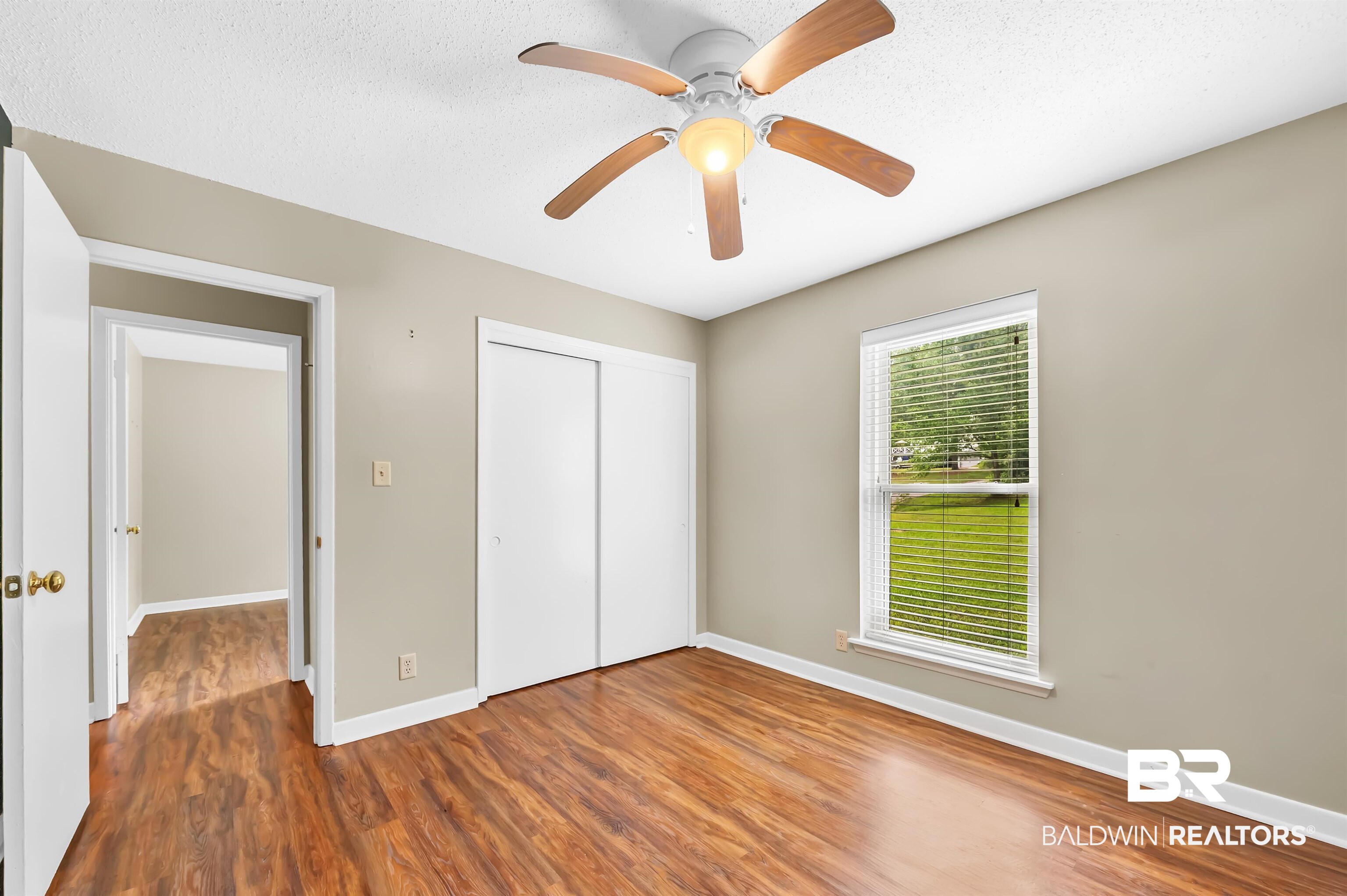 28 Caisson Trace Spanish Fort, AL 36527 - Photo 36 of 51 Unfurnished bedroom with wood finished floors, a closet, ceiling fan, baseboards, and a textured ceiling