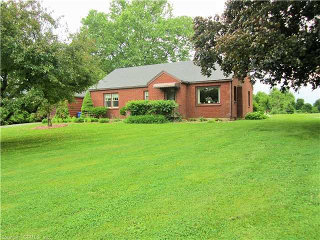 a front view of a house with yard and green space