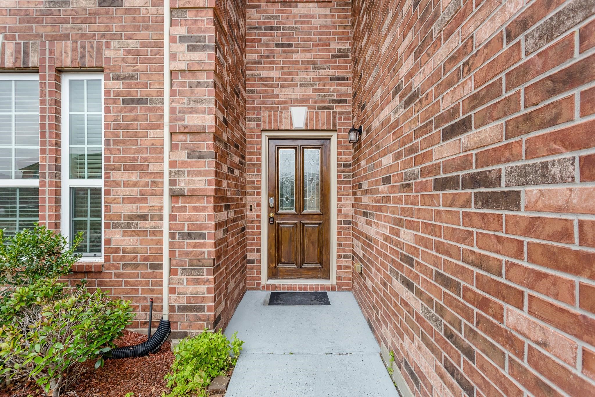 a view of a brick house with a large window