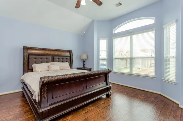 a bed sitting in a bedroom next to a window