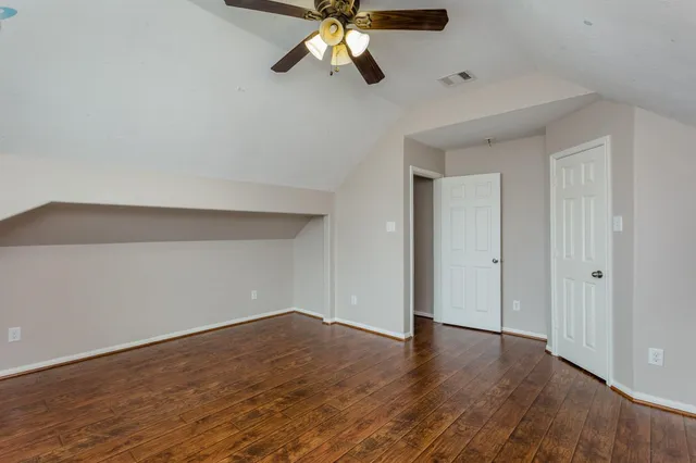 a view of an empty room and wooden floor