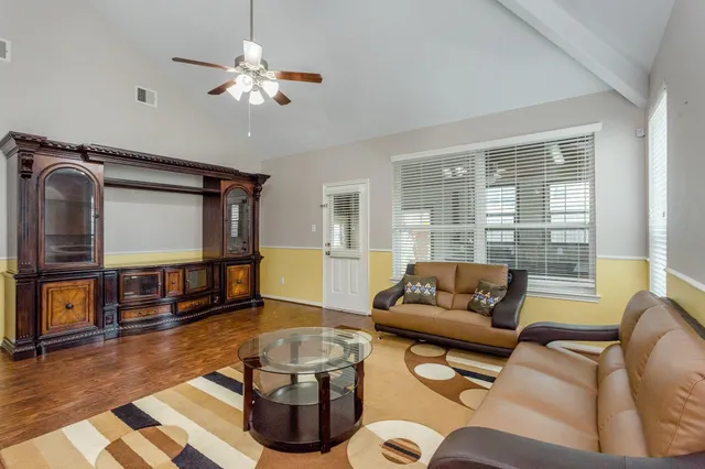 a living room with furniture and a large window