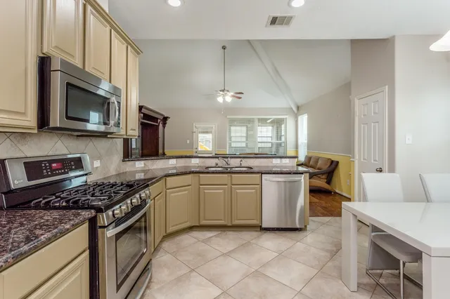 a kitchen with a sink stove and microwave