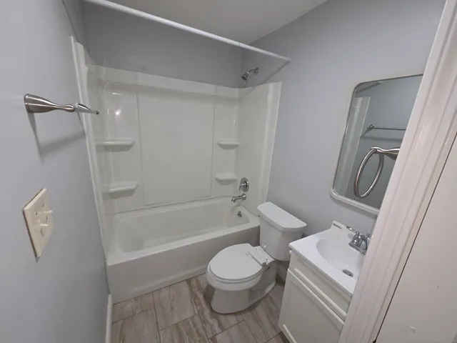 a bathroom with a toilet a sink and a bathtub