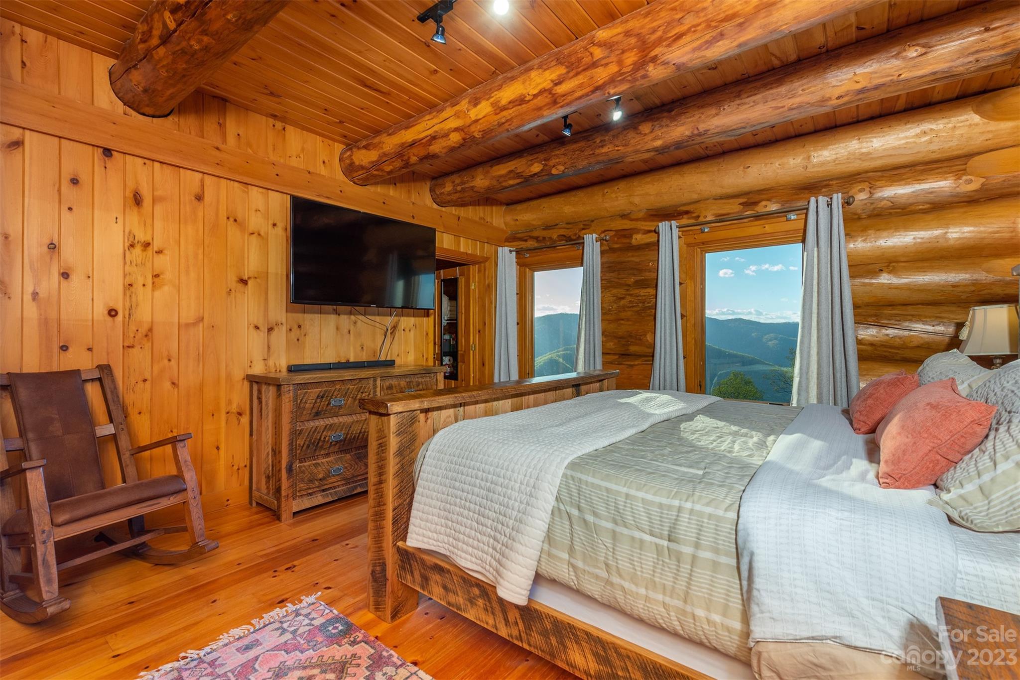 685 Talbot Drive Canton, NC 28716 - Photo 14 of 48 a bedroom with a bed television and a large window