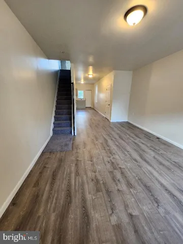 a kitchen with stainless steel appliances wooden floors and view living room
