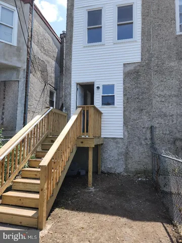 a view of staircase with wooden floor and white walls