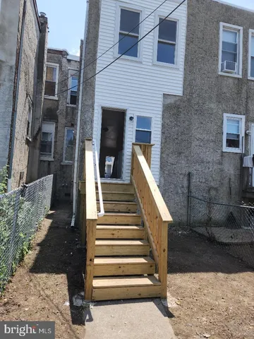 a view of a patio with two couches and large trees