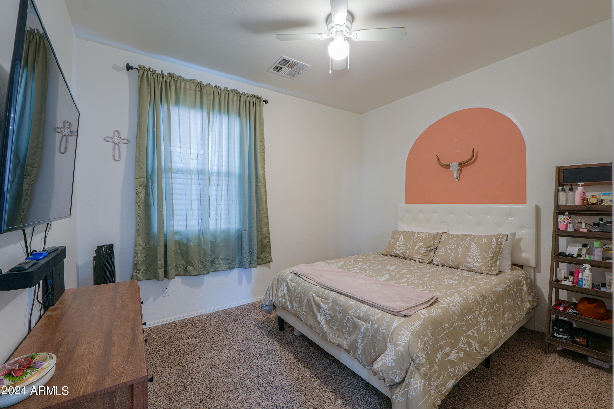 44236 Roth Road Maricopa, AZ 85138 - Photo 14 of 45 a bedroom with a bed and a chandelier