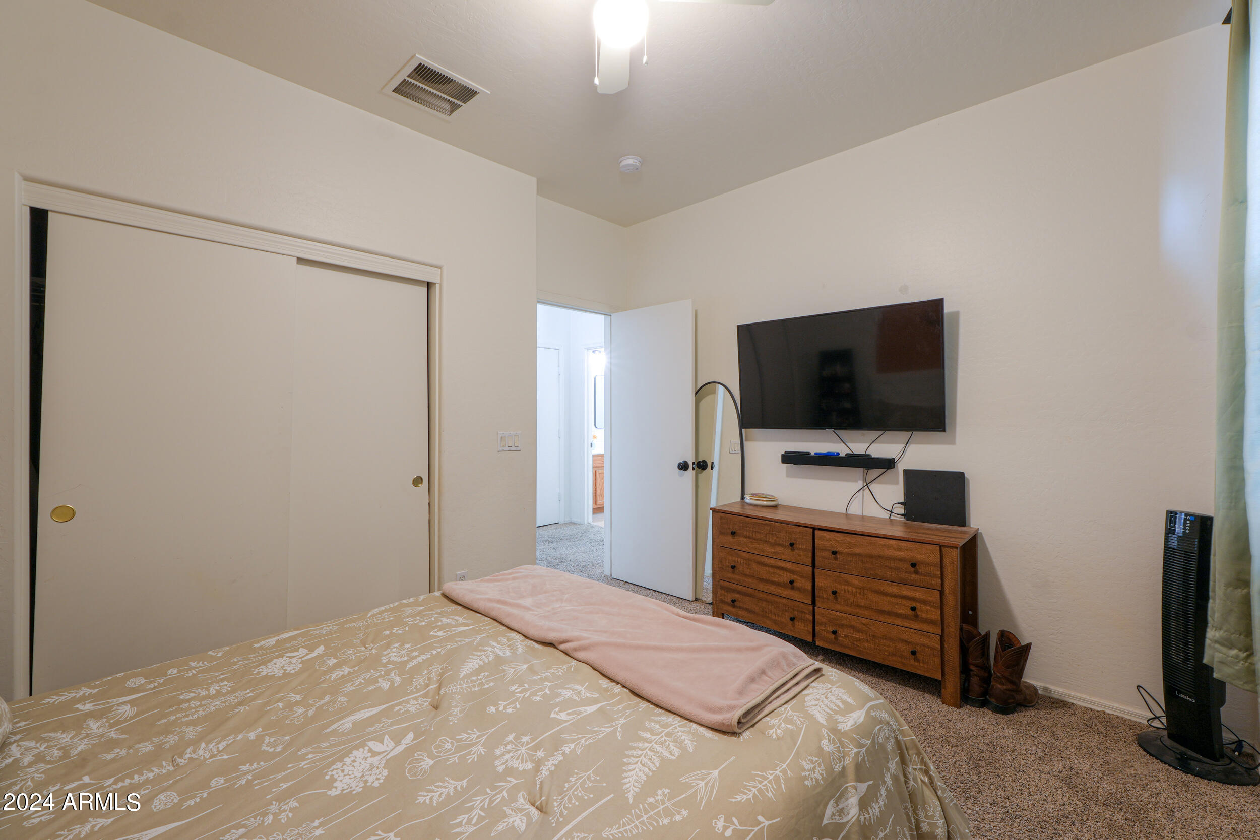 44236 Roth Road Maricopa, AZ 85138 - Photo 15 of 45 a bedroom with a flat screen television and a bed