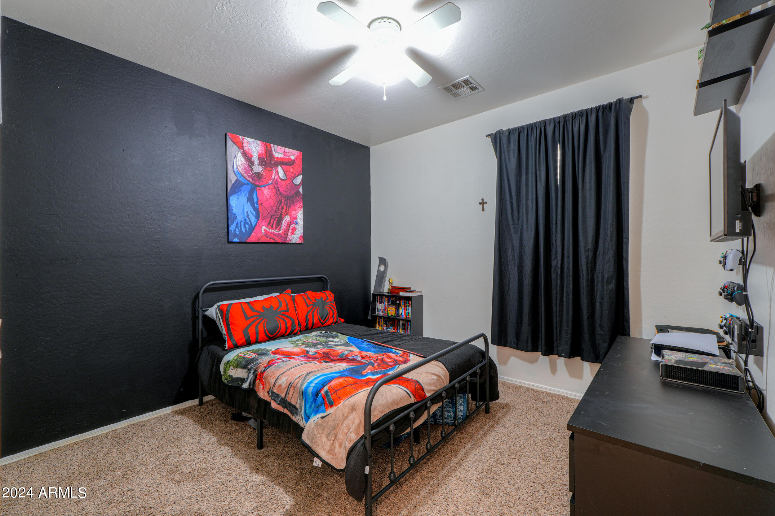 44236 Roth Road Maricopa, AZ 85138 - Photo 16 of 45 a bedroom with a bed and a flat screen tv