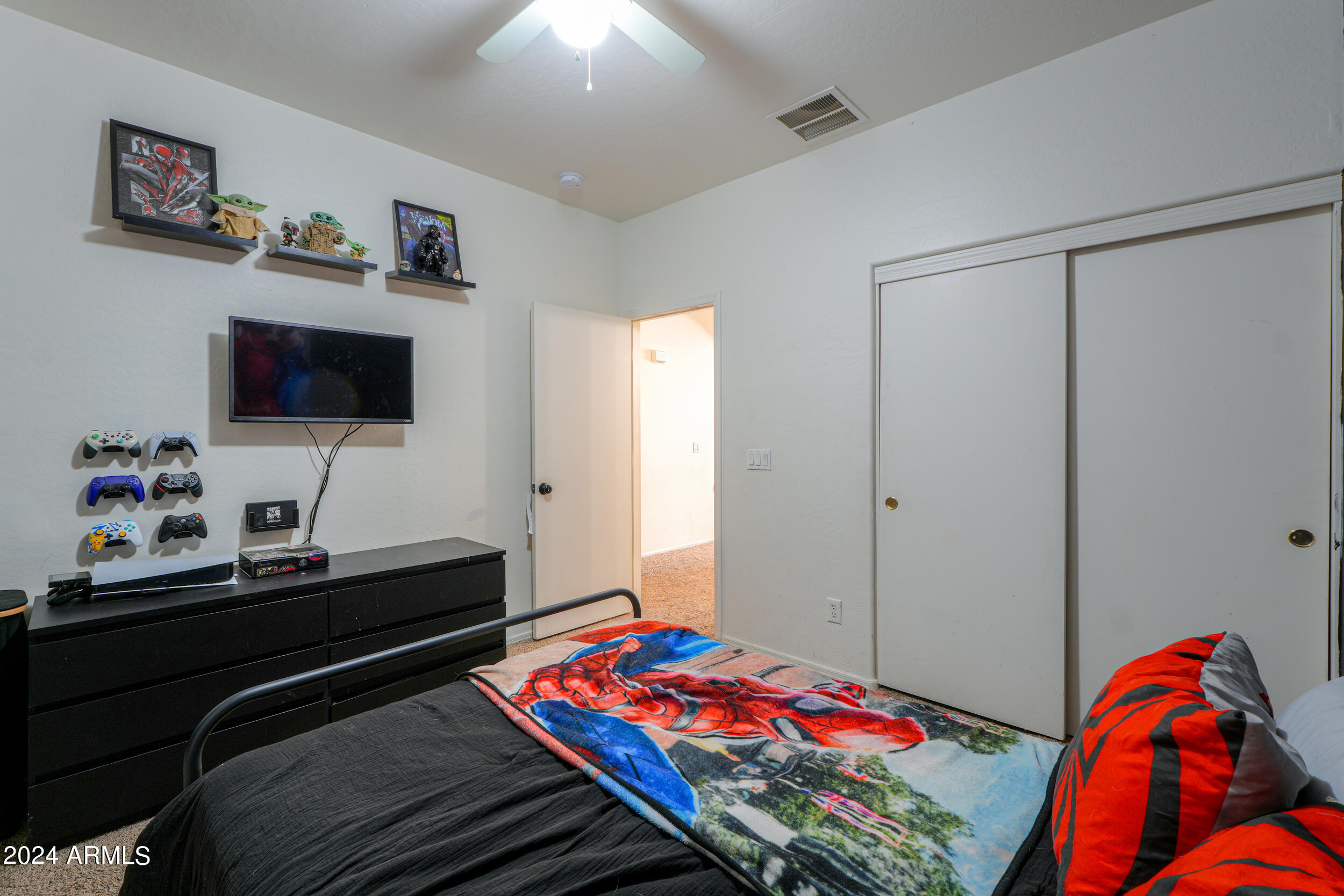 44236 Roth Road Maricopa, AZ 85138 - Photo 17 of 45 a bedroom with a bed and a flat screen tv