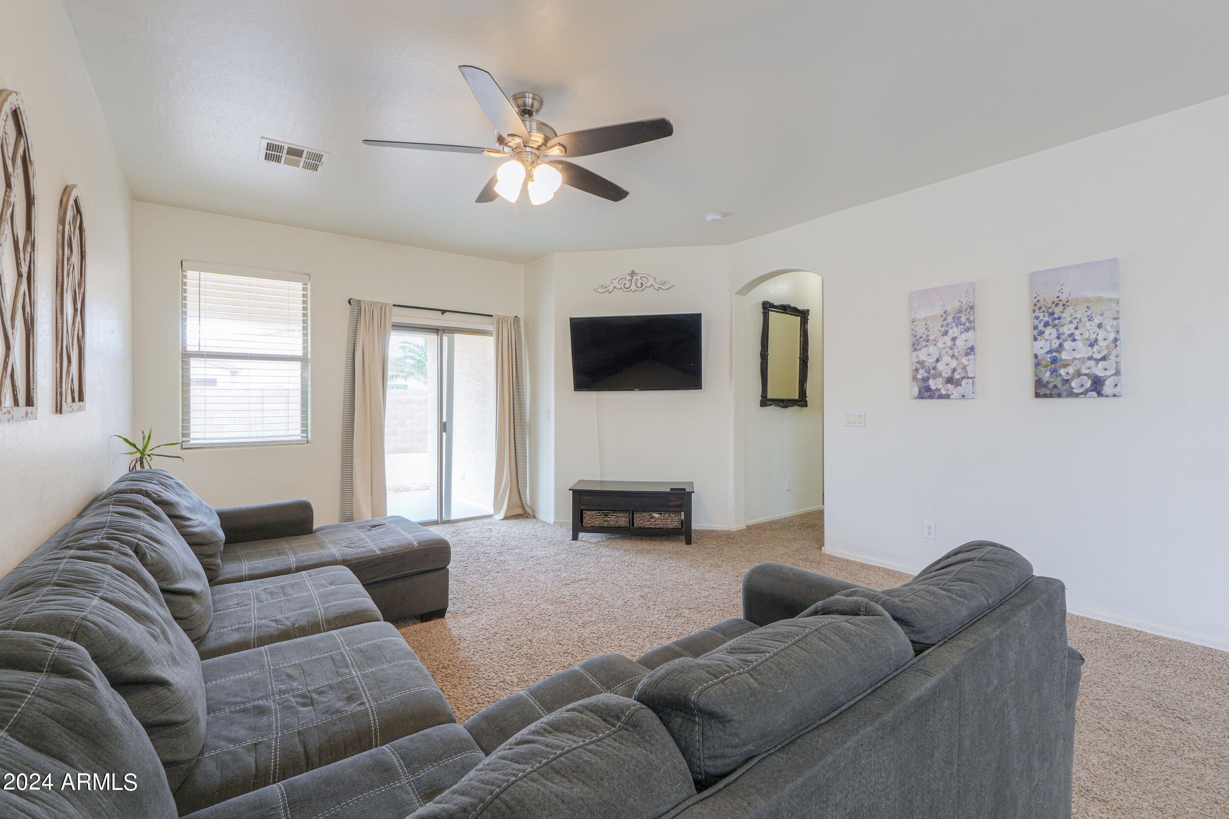 44236 Roth Road Maricopa, AZ 85138 - Photo 24 of 45 a living room with furniture and a flat screen tv