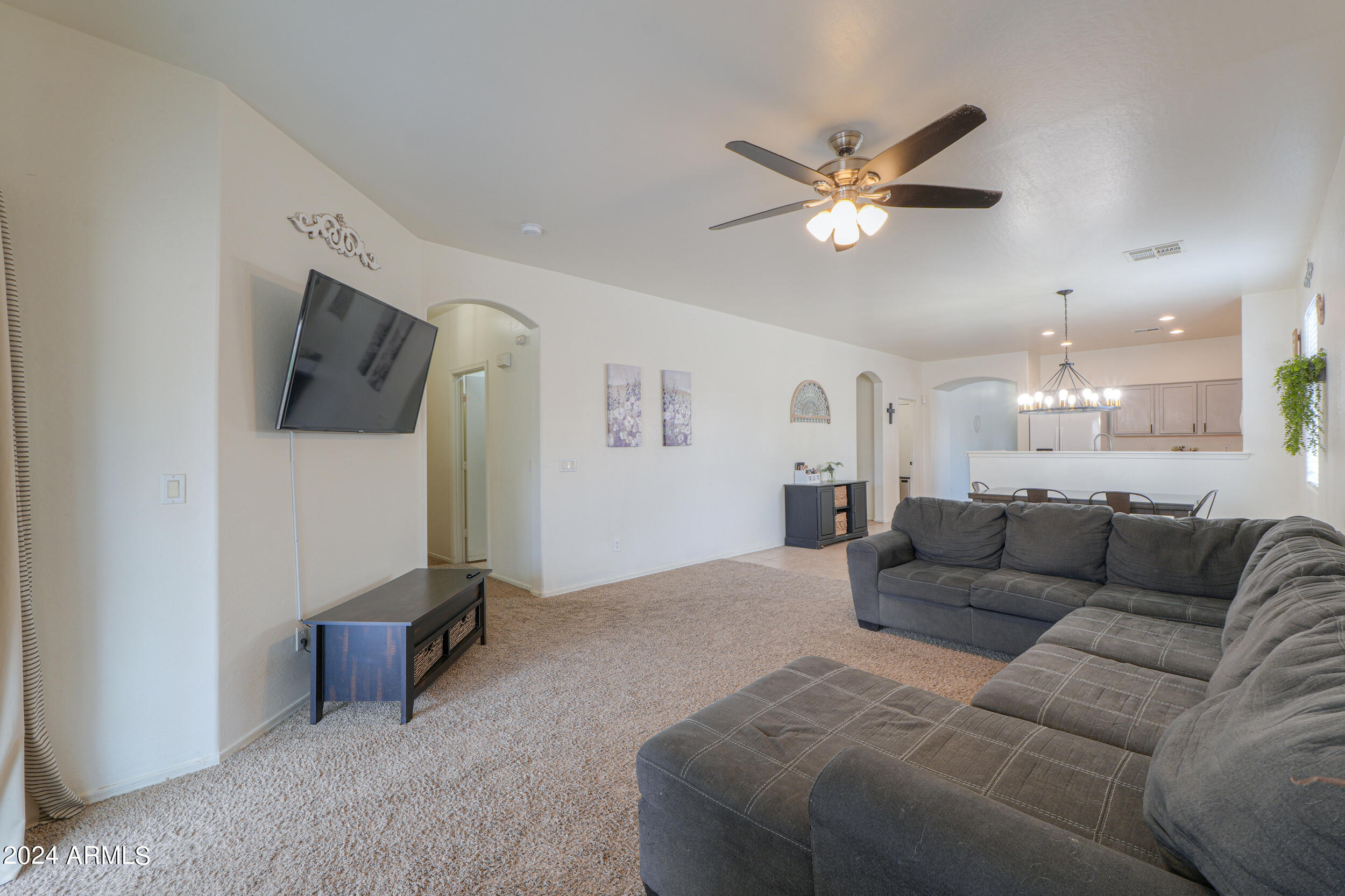 44236 Roth Road Maricopa, AZ 85138 - Photo 25 of 45 a living room with furniture and a flat screen tv