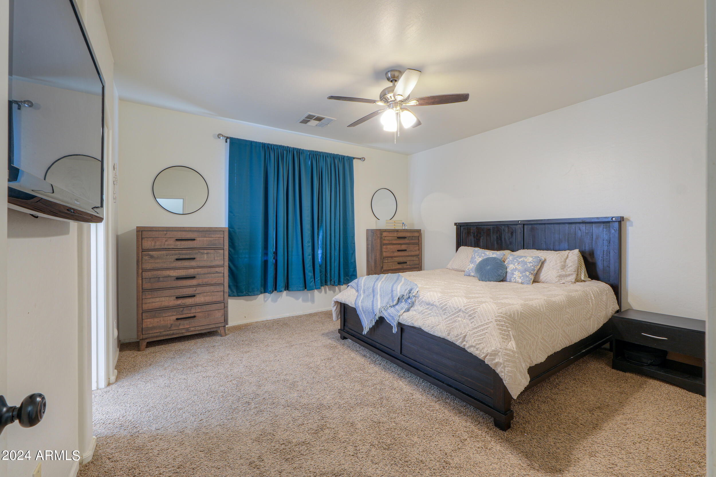 44236 Roth Road Maricopa, AZ 85138 - Photo 29 of 45 a spacious bedroom with a bed and a dresser