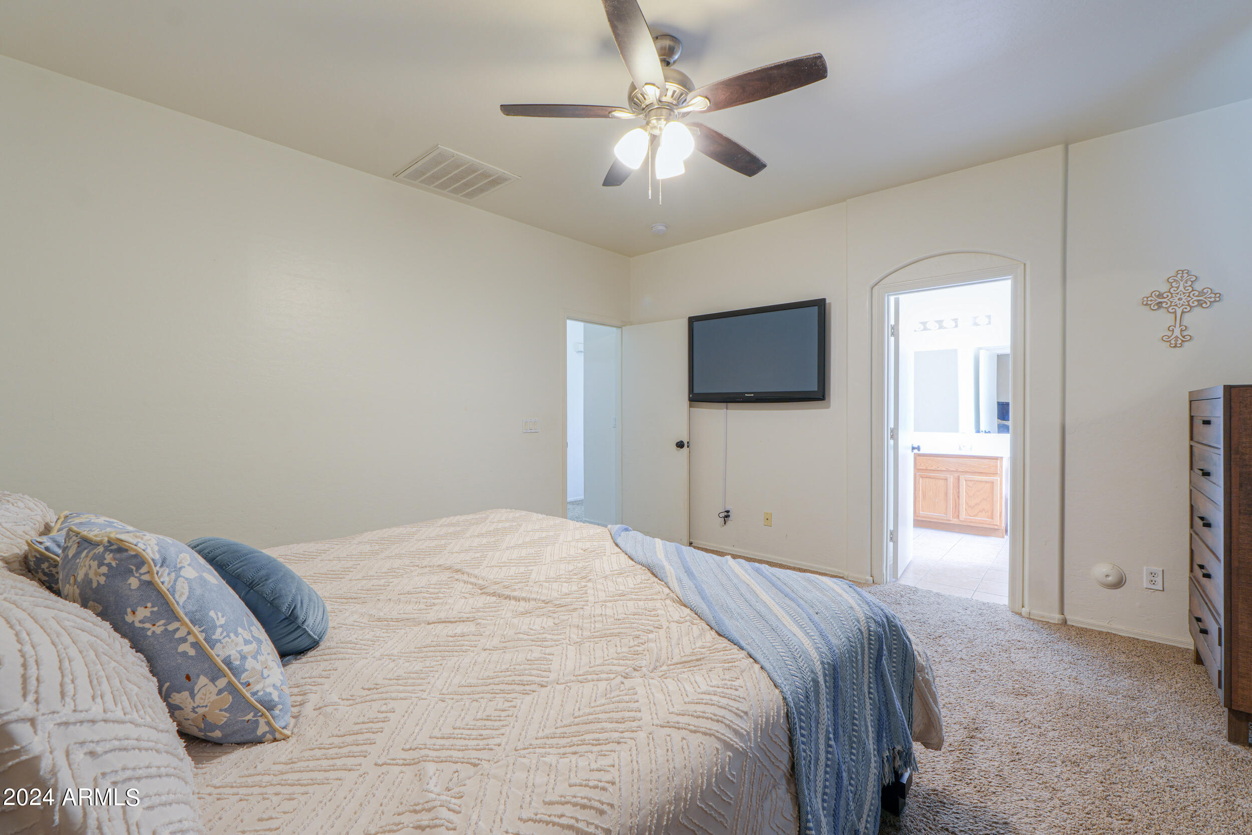 44236 Roth Road Maricopa, AZ 85138 - Photo 30 of 45 a bedroom with a bed and a flat tv screen on dresser