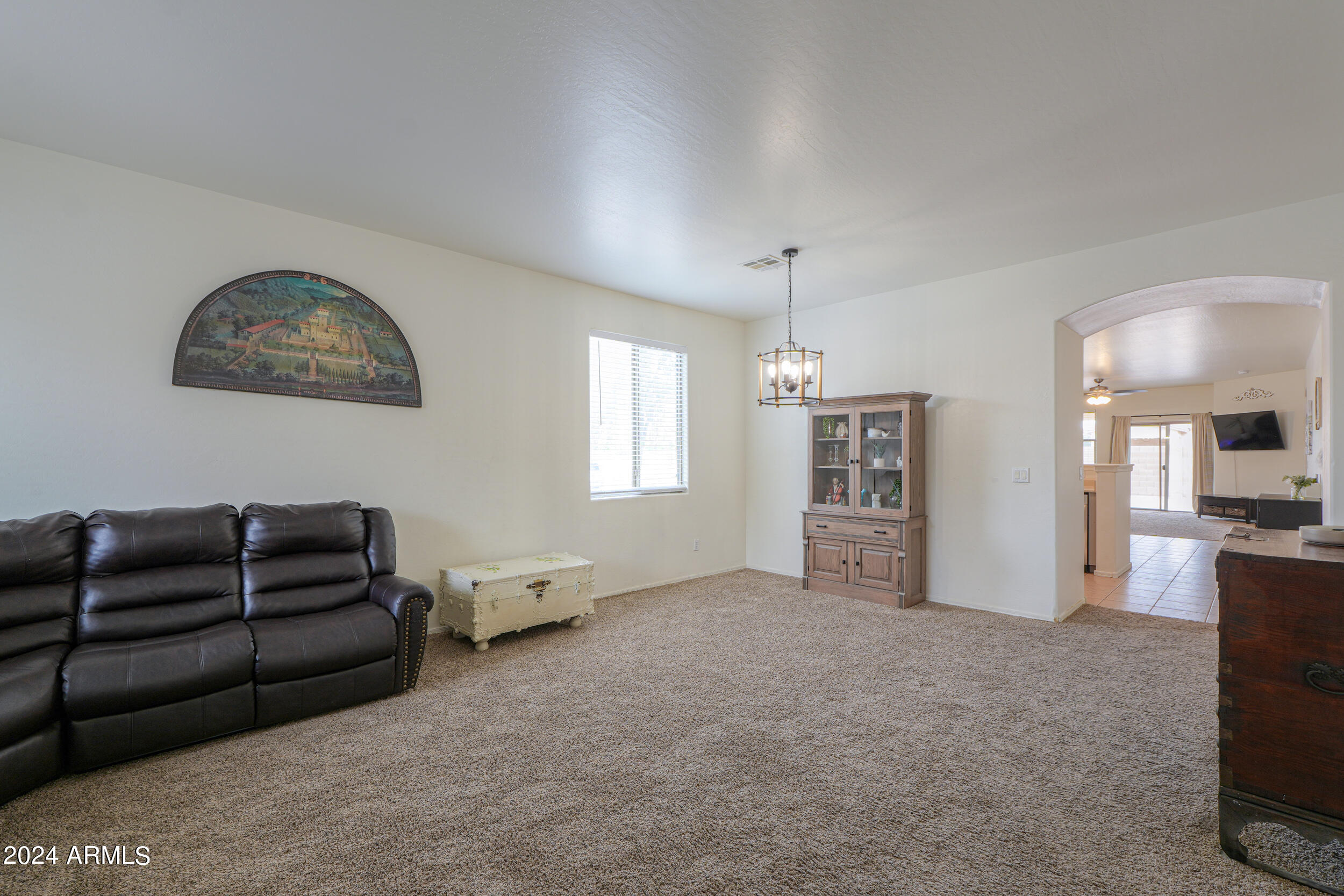 44236 Roth Road Maricopa, AZ 85138 - Photo 4 of 45 a living room with furniture a couch and a flat screen tv