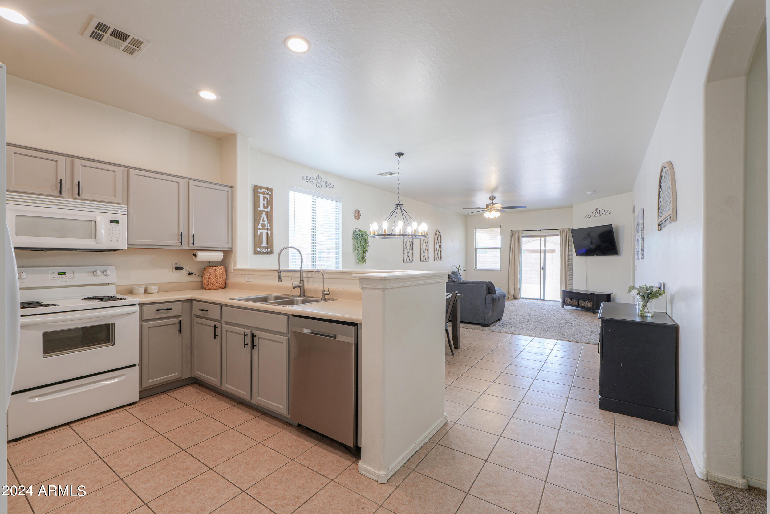 44236 Roth Road Maricopa, AZ 85138 - Photo 7 of 45 a kitchen with a sink and white cabinets