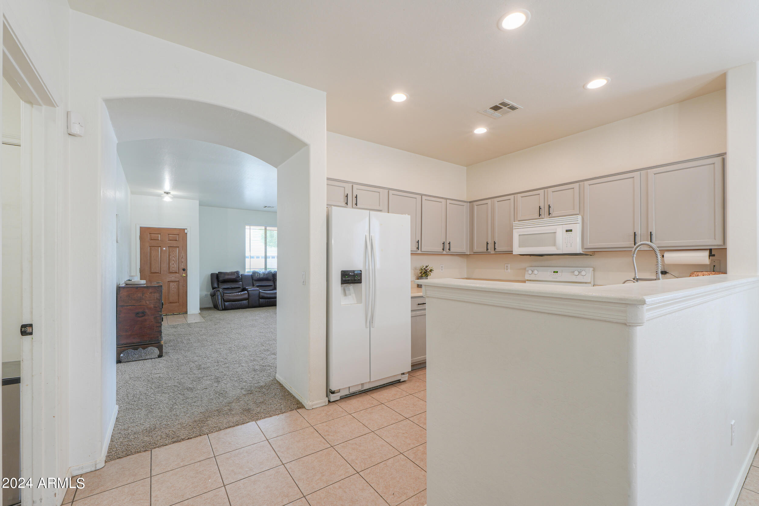 44236 Roth Road Maricopa, AZ 85138 - Photo 8 of 45 a kitchen with refrigerator and cabinets