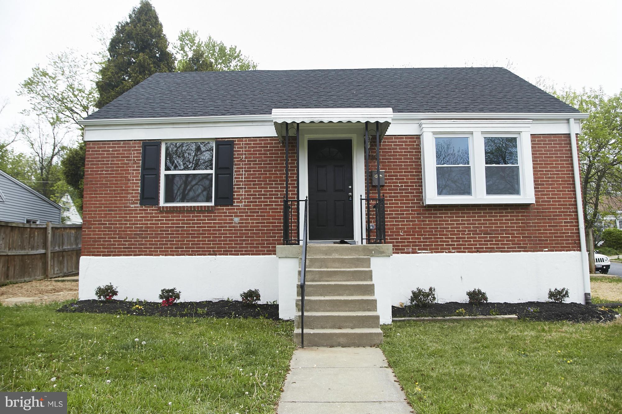 719 Cliffedge Road Baltimore, MD 21208 - Photo 1 of 30 a front view of a house with a yard