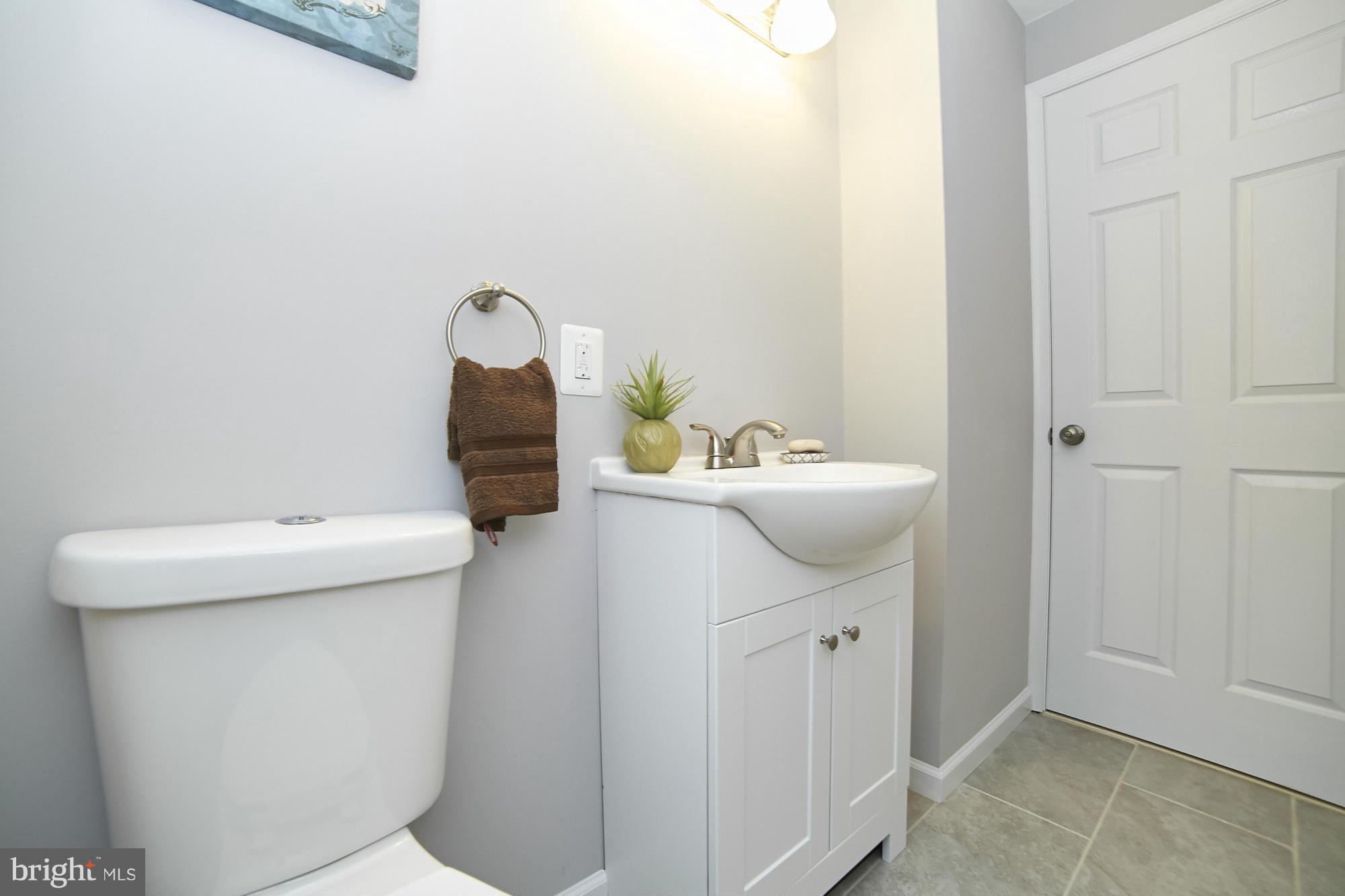 719 Cliffedge Road Baltimore, MD 21208 - Photo 13 of 30 a bathroom with a sink a toilet and mirror