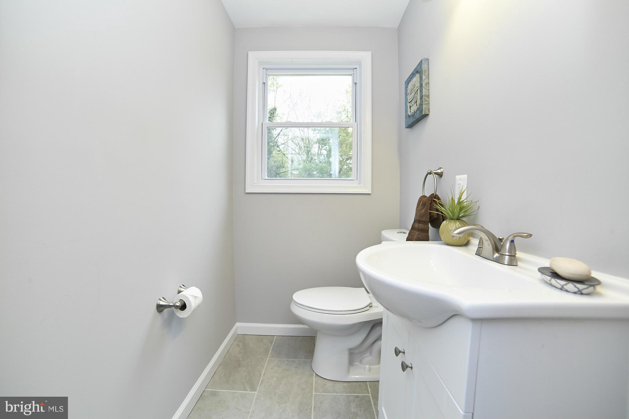 719 Cliffedge Road Baltimore, MD 21208 - Photo 14 of 30 a bathroom with a sink toilet and mirror