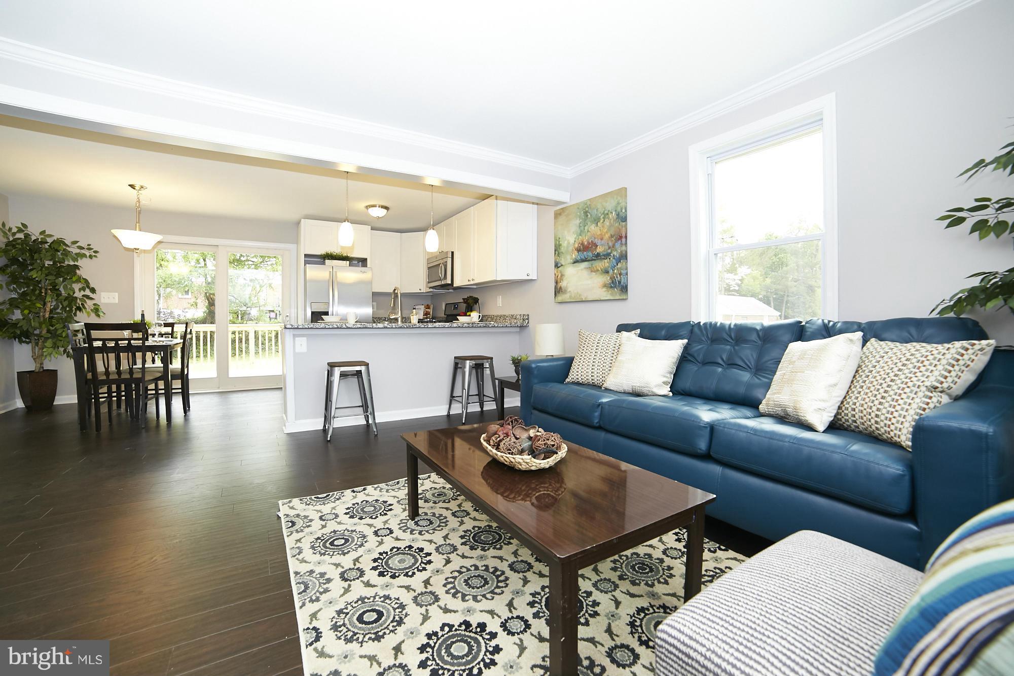 719 Cliffedge Road Baltimore, MD 21208 - Photo 3 of 30 a living room with furniture wooden floor and a table