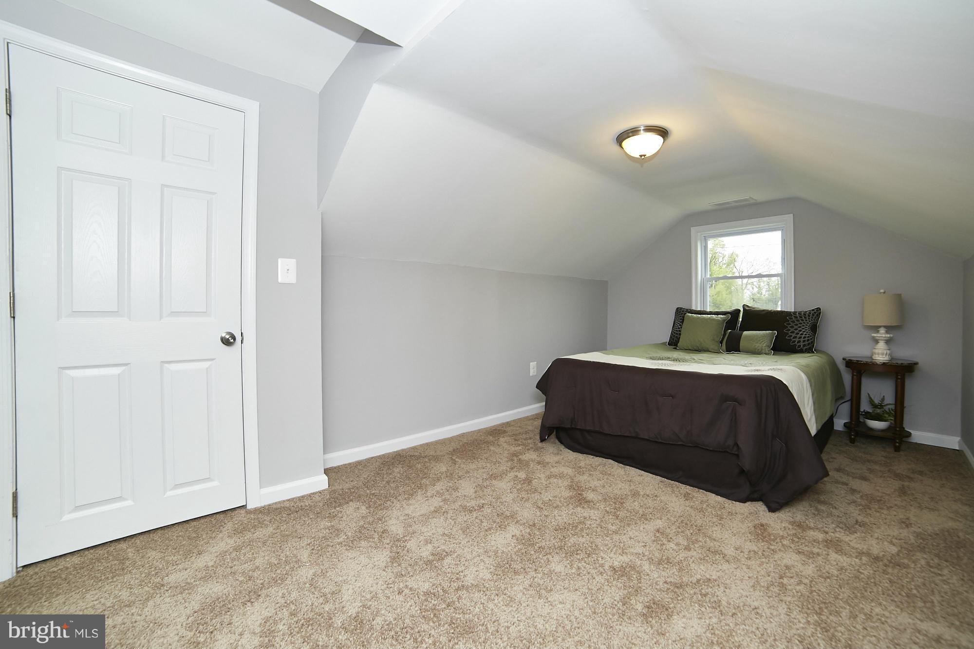 719 Cliffedge Road Baltimore, MD 21208 - Photo 22 of 30 a bedroom with a bed and a window