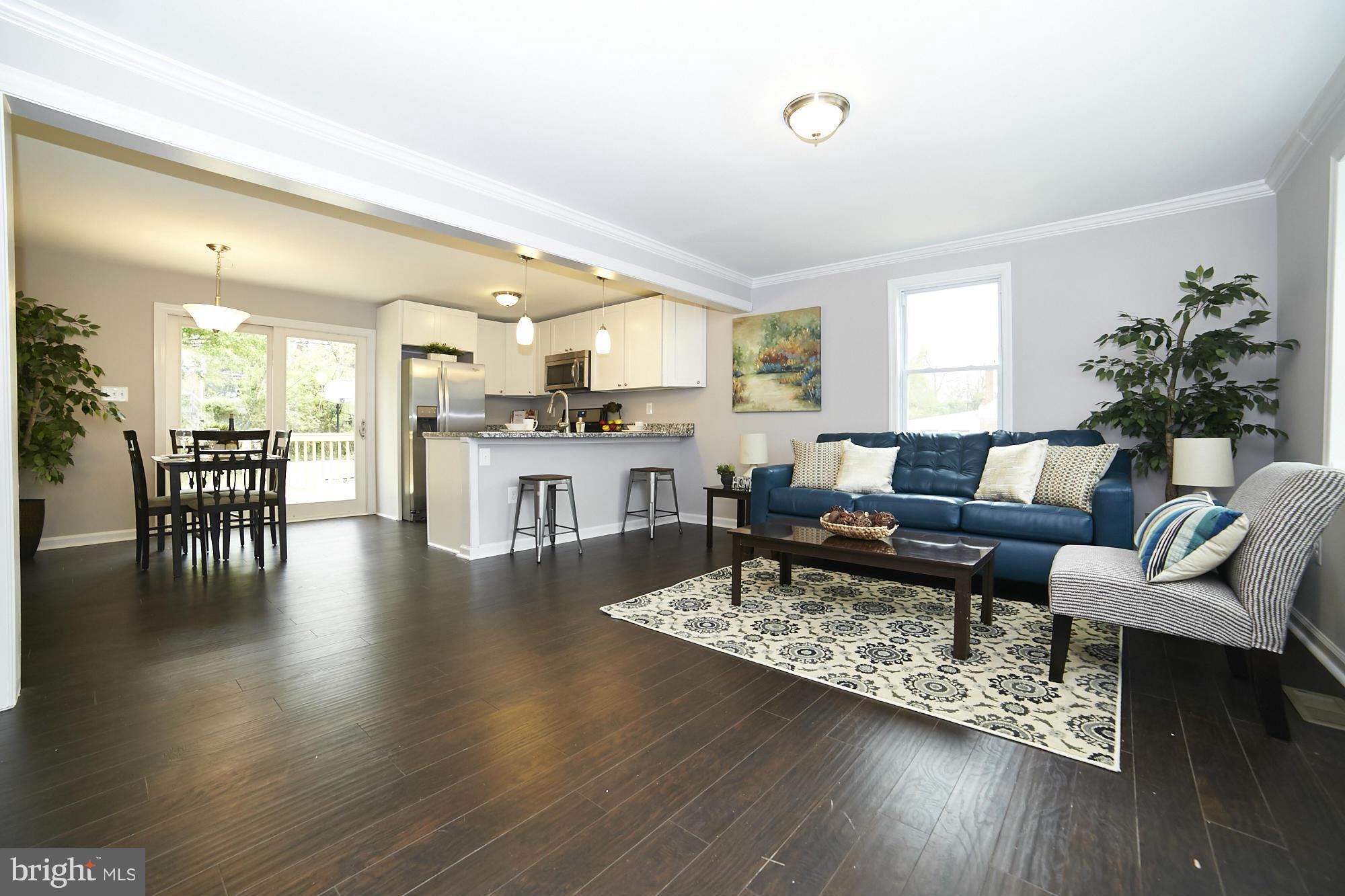 719 Cliffedge Road Baltimore, MD 21208 - Photo 6 of 30 a living room with furniture wooden floor and a large window