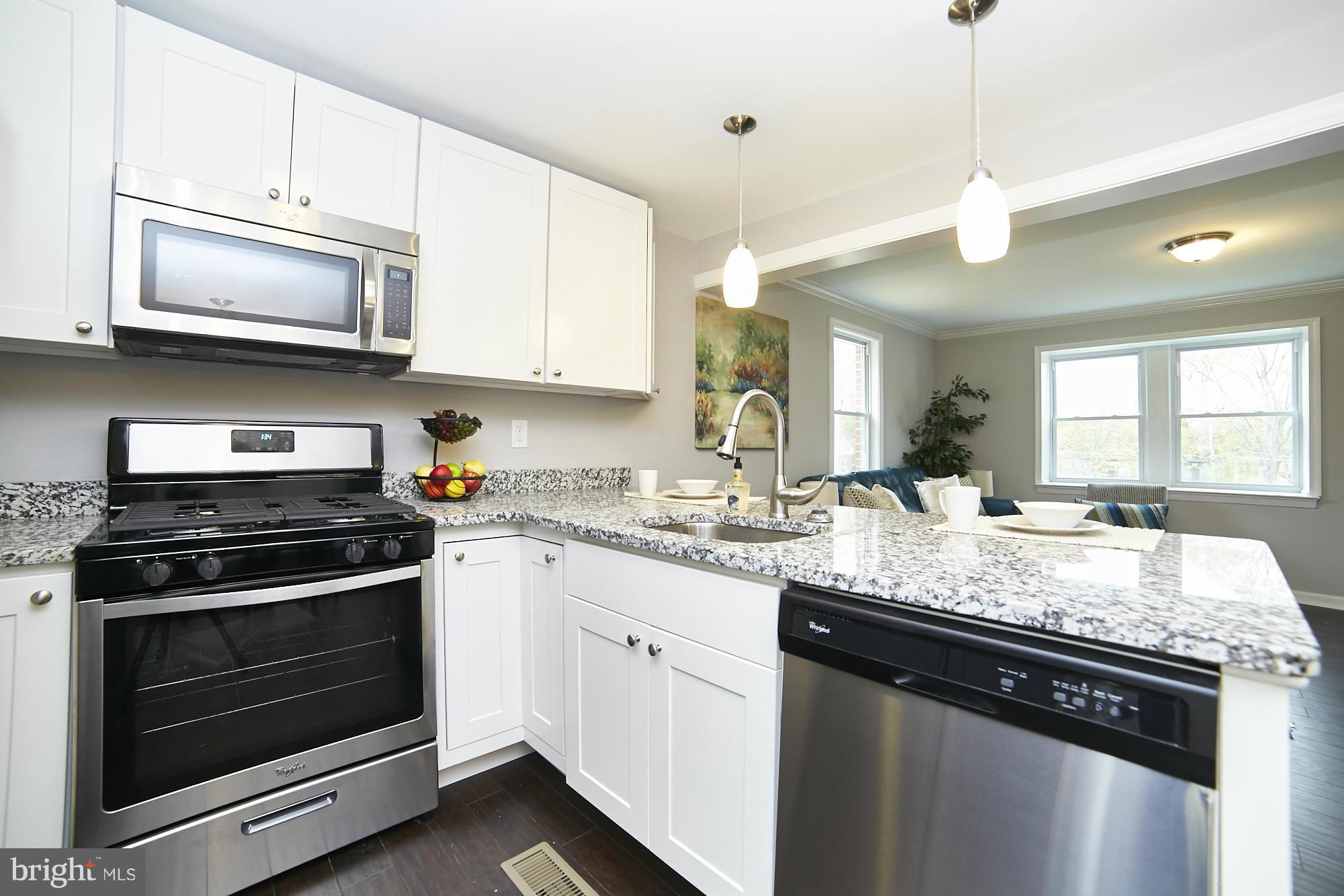 719 Cliffedge Road Baltimore, MD 21208 - Photo 10 of 30 a kitchen with granite countertop a stove sink and microwave