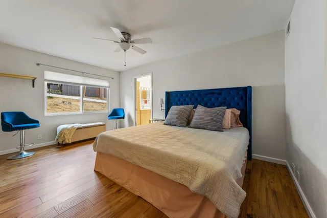 a view of a house with backyard and trees