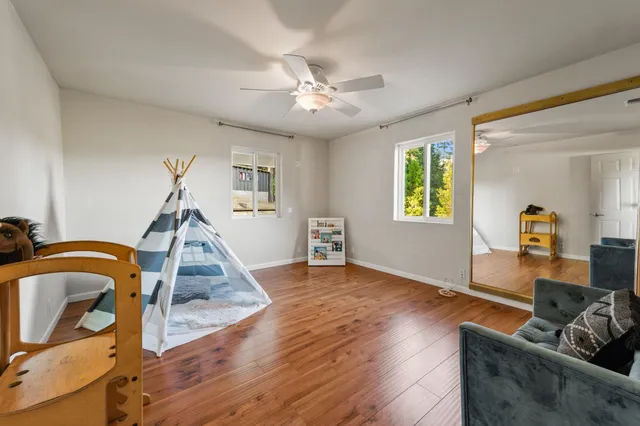 a view of a house with backyard and trees