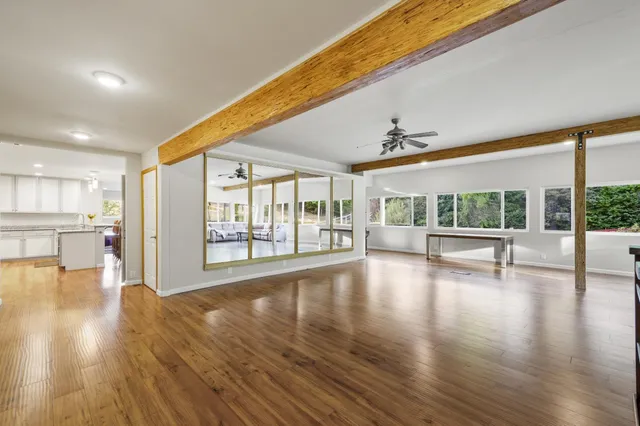 a front view of a house with a garden and trees