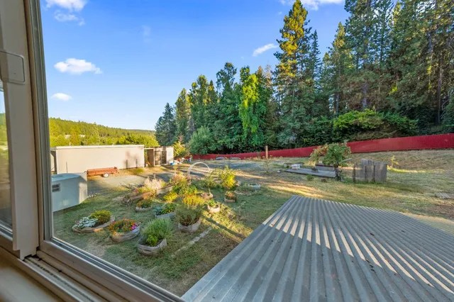 a kitchen with stainless steel appliances granite countertop a refrigerator a sink dishwasher a stove and white countertops with wooden floor