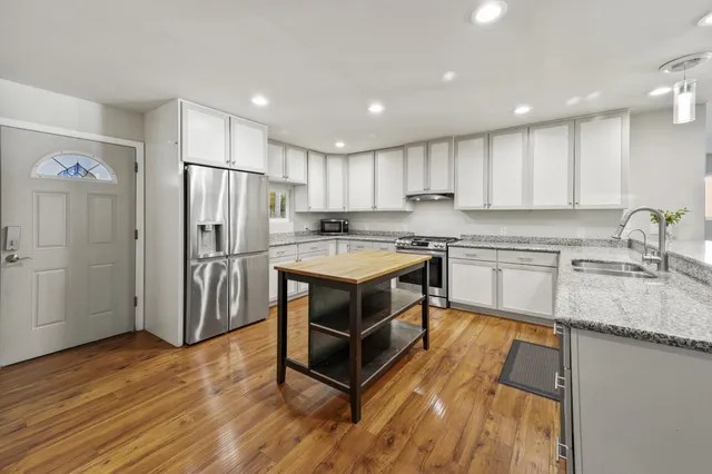 a living room with couches and a coffee table with wooden floor