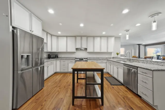 a view of a living room and dining room with wooden floor