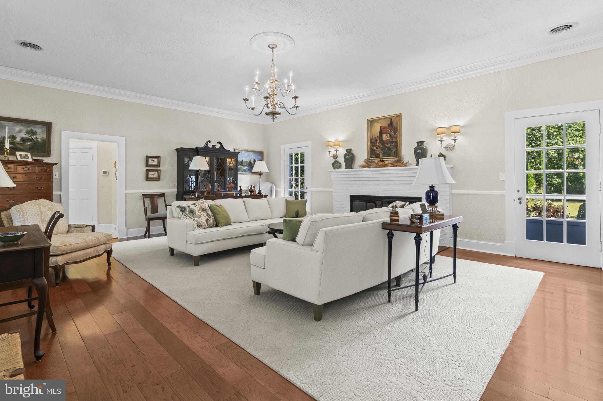 8150 Fairground Road La Plata, MD 20646 - Photo 27 of 100 a living room with furniture and a chandelier