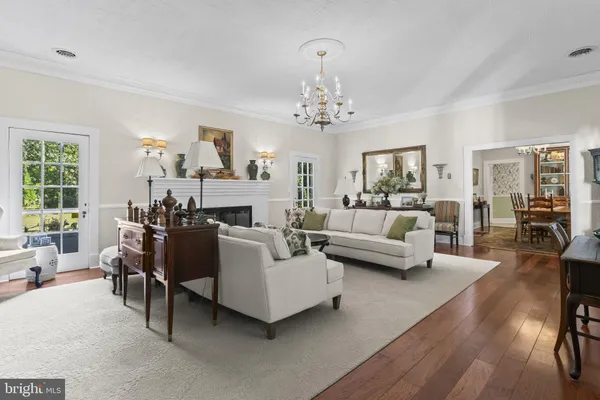 a view of a livingroom with furniture window wooden floor and front door