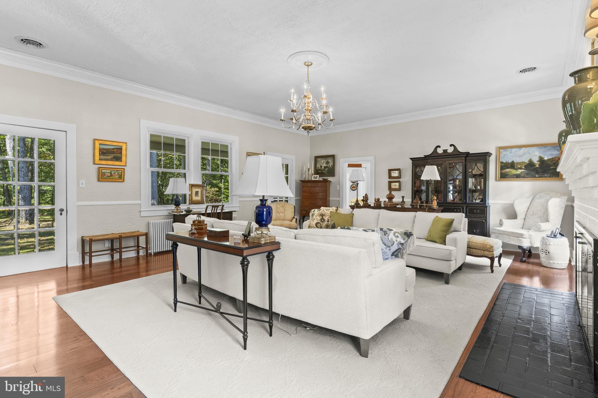 8150 Fairground Road La Plata, MD 20646 - Photo 33 of 100 a living room with furniture and a chandelier