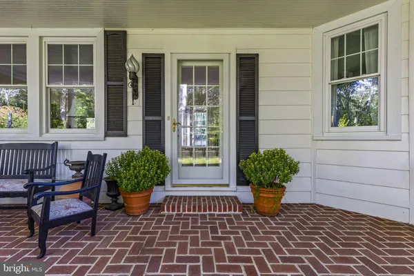 a front view of a house with a yard and green space