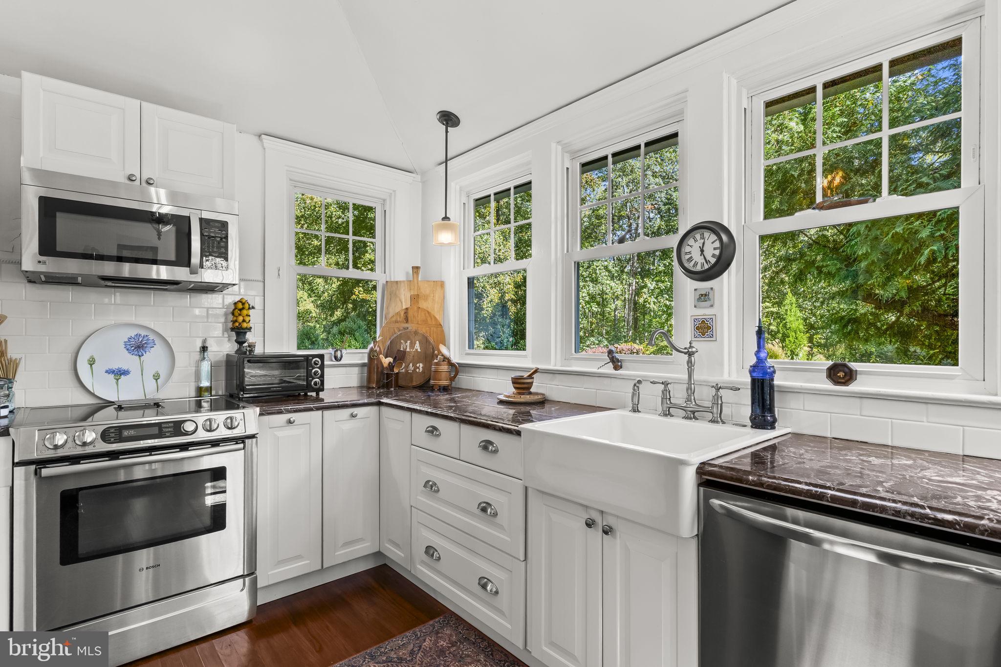 8150 Fairground Road La Plata, MD 20646 - Photo 59 of 100 a kitchen with granite countertop a stove a sink and a microwave