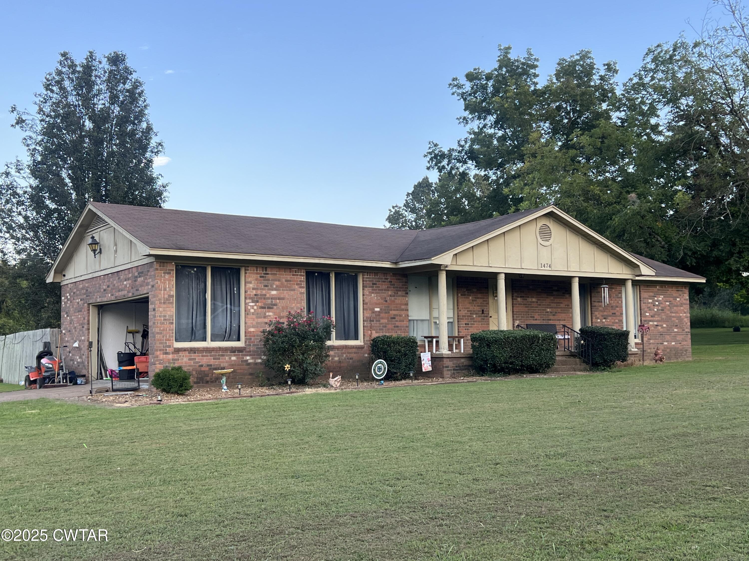 1474 Riverside Drive Jackson, TN 38301 - Photo 2 of 5 a front view of a house with garden
