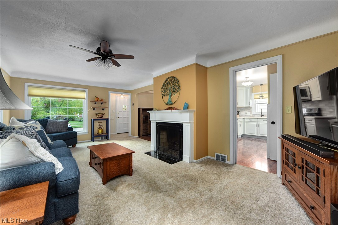 19646 Henry Road Fairview Park, OH 44126 - Photo 3 of 35 Living room featuring a fireplace, and ceiling fan.
